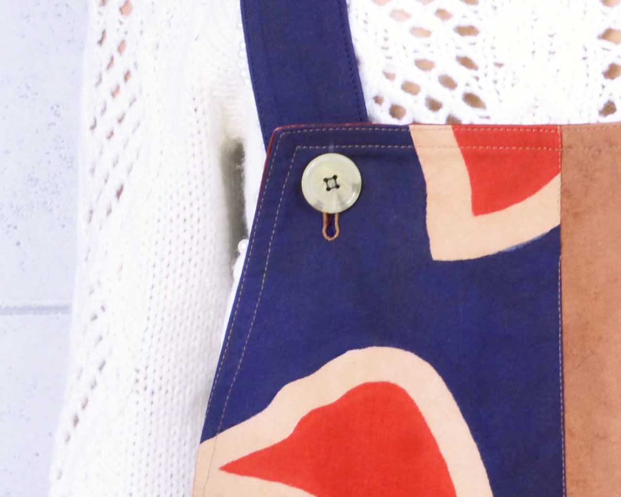 Persimmon-dyed salopettes with a big fishing flag